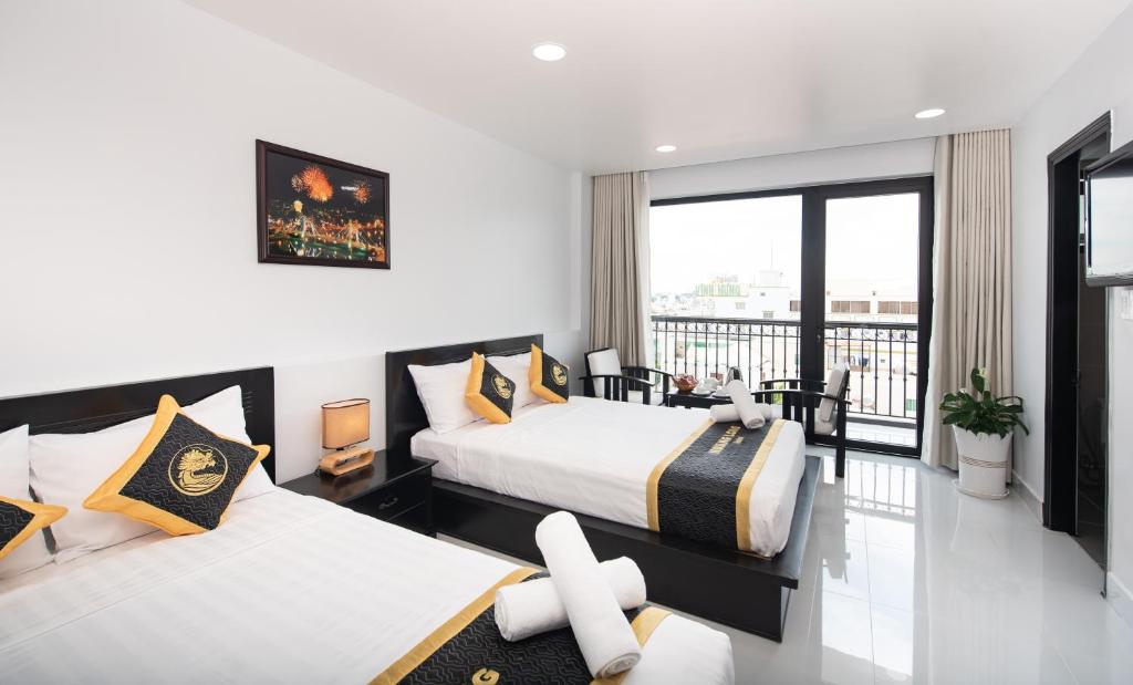 Giường trong phòng chung tại Hoang Long Hotel Phan Thiết