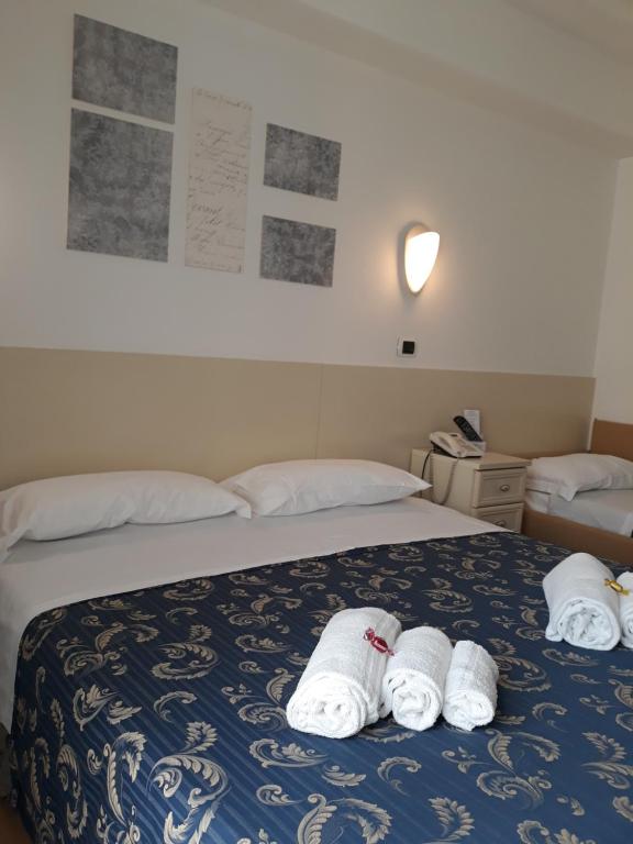 Łóżko lub łóżka w pokoju w obiekcie Hotel La Palazzina