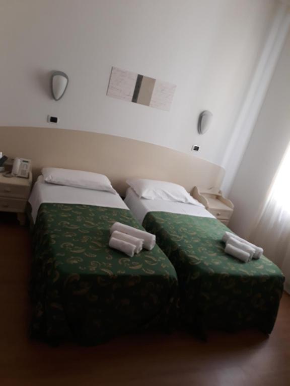Łóżko lub łóżka w pokoju w obiekcie Hotel La Palazzina