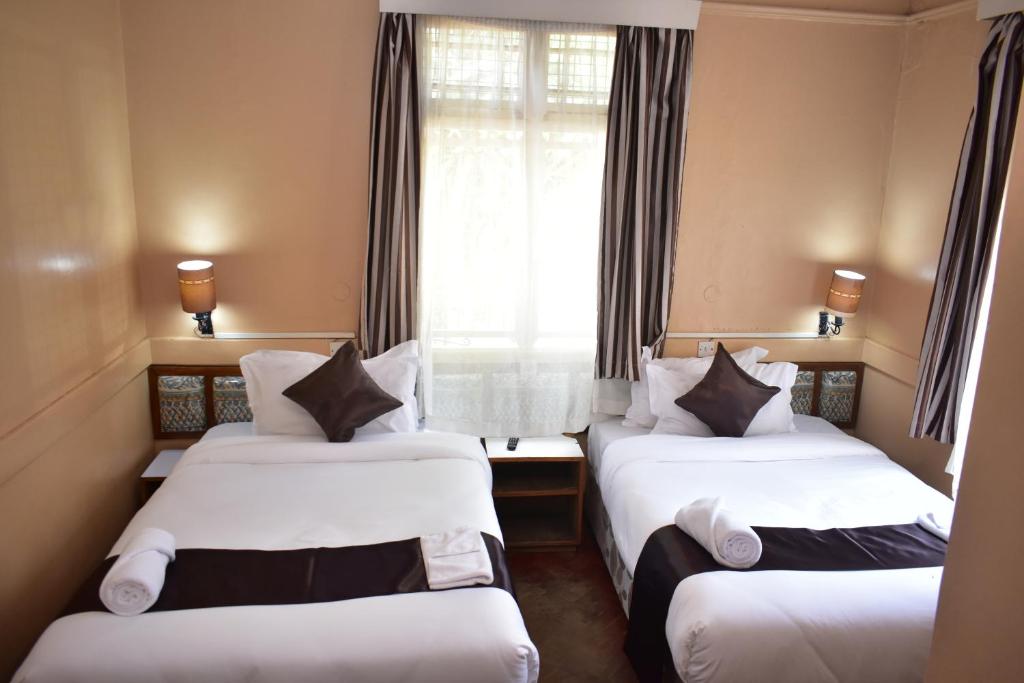 Postel nebo postele na pokoji v ubytování Impala Hotel Parklands