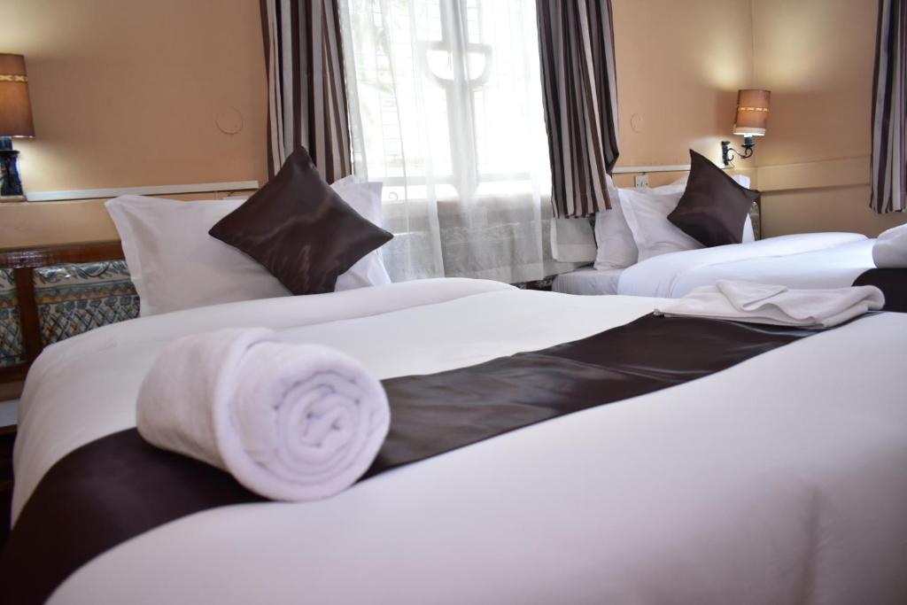 Postel nebo postele na pokoji v ubytování Impala Hotel Parklands