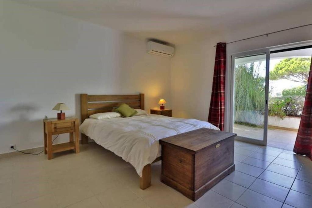 a bedroom with a bed and a large window at Casa Vale Do Lobo 832A - Charming Townhouse AC few minutes walk from Beach Praca in Vale do Lobo