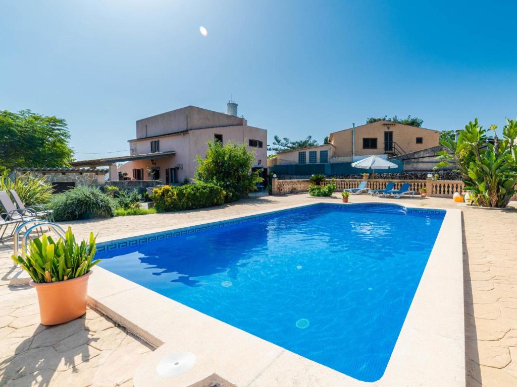 a swimming pool in front of a house at Holiday Home Can Josepot by Interhome in Alcudia