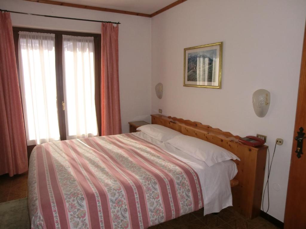 Posteľ alebo postele v izbe v ubytovaní Hotel Piccolo Mondo