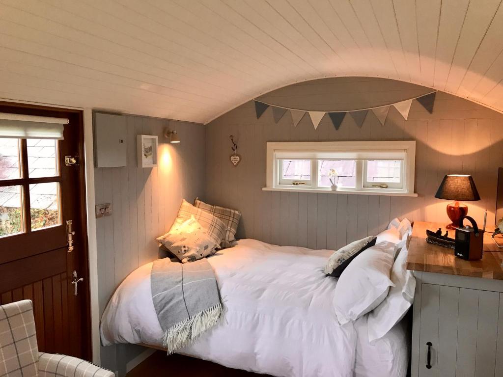 a bedroom with a large bed in a room at Sheelin Shepherds Hut in Cavan