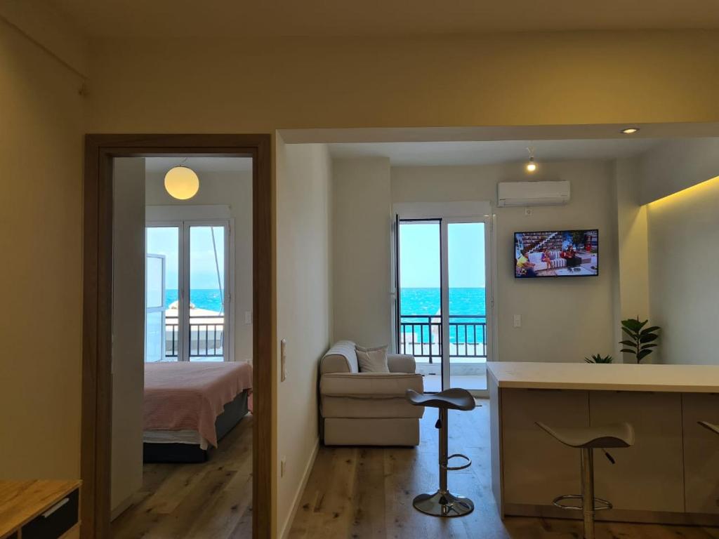 a bedroom with a bed and a view of the ocean at Grace Seaside in Loutraki