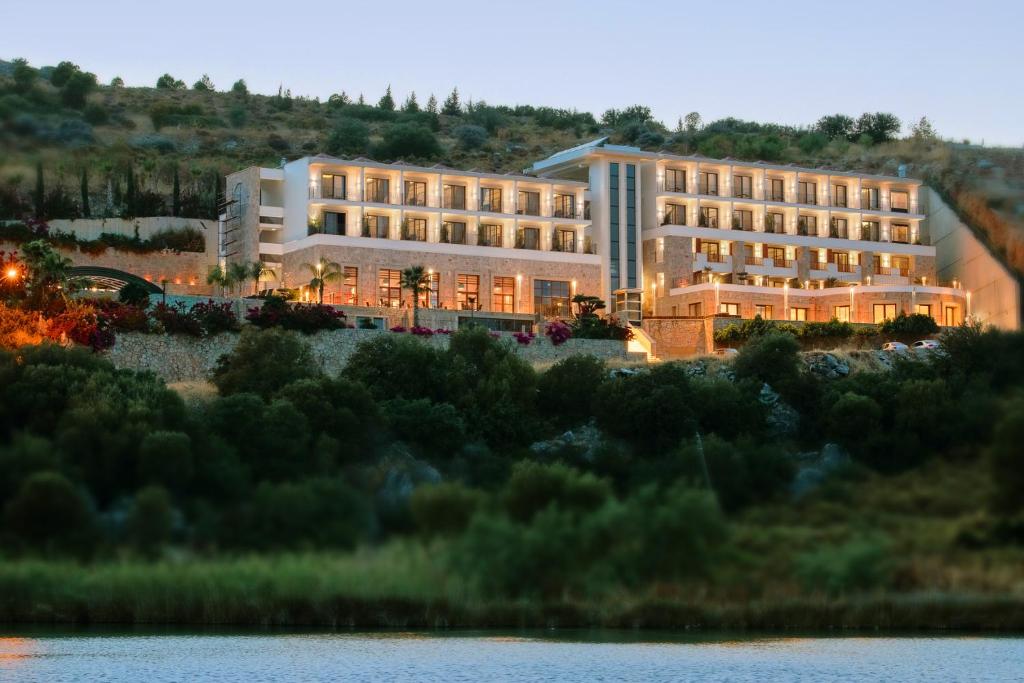 a hotel on the shore of a lake at Cape Krio Boutique Hotel & SPA - Over 9 years old Adult Only in Datca