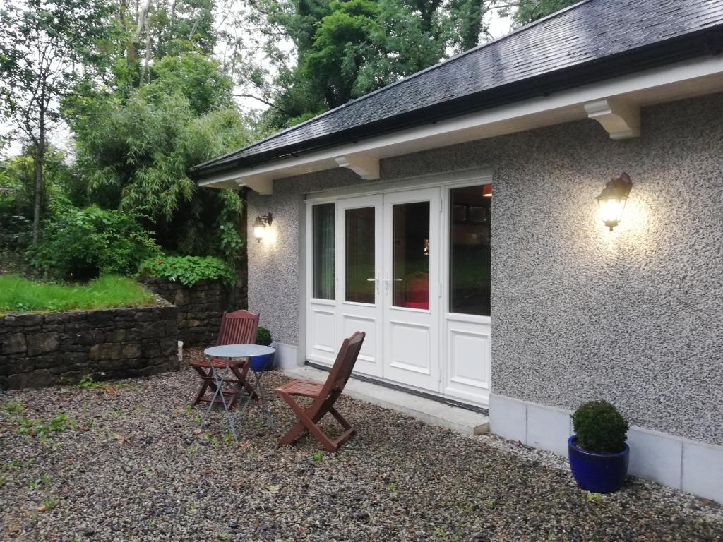 a house with a white door and a table and chairs at 1 bed studio in Castlebar