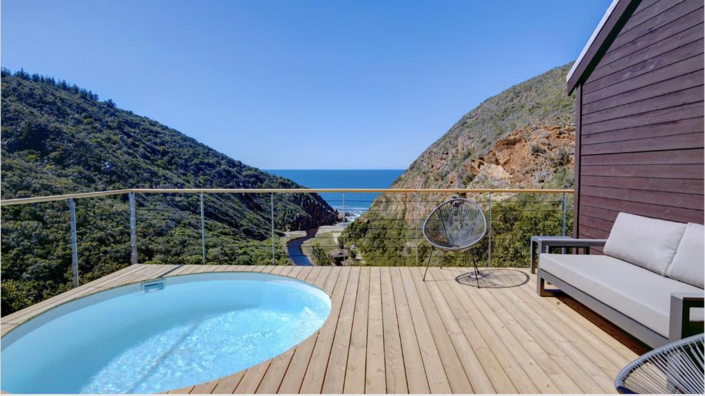 a hot tub on a deck with a view of the ocean at Earth Wind and Ocean 8 in George