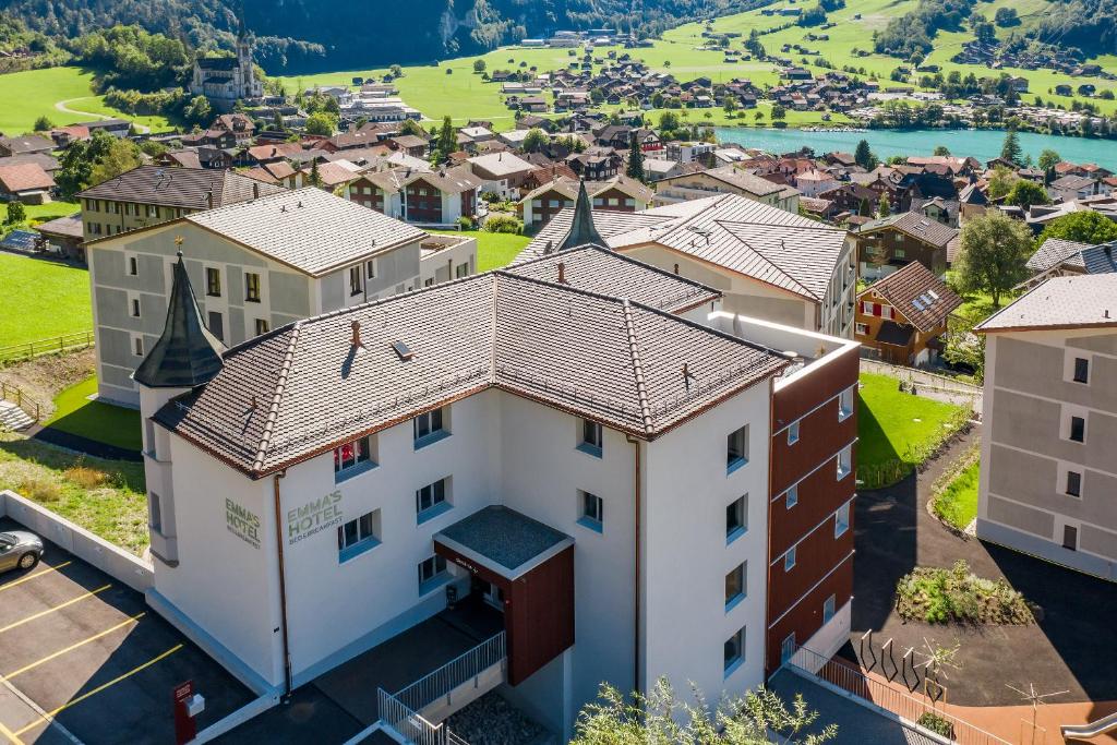 an aerial view of a building in a suburb at Emma's B&B - Self Check-in Hotel in Lungern