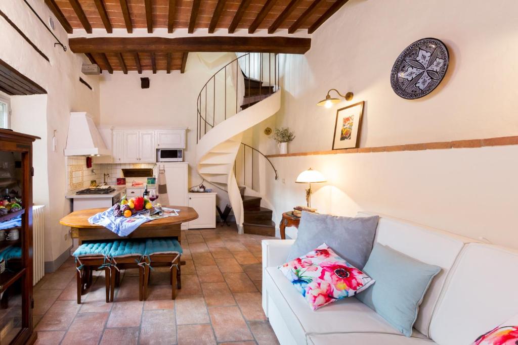
a living room filled with furniture and a table at Casa Amorino- Together Tuscany in Cortona
