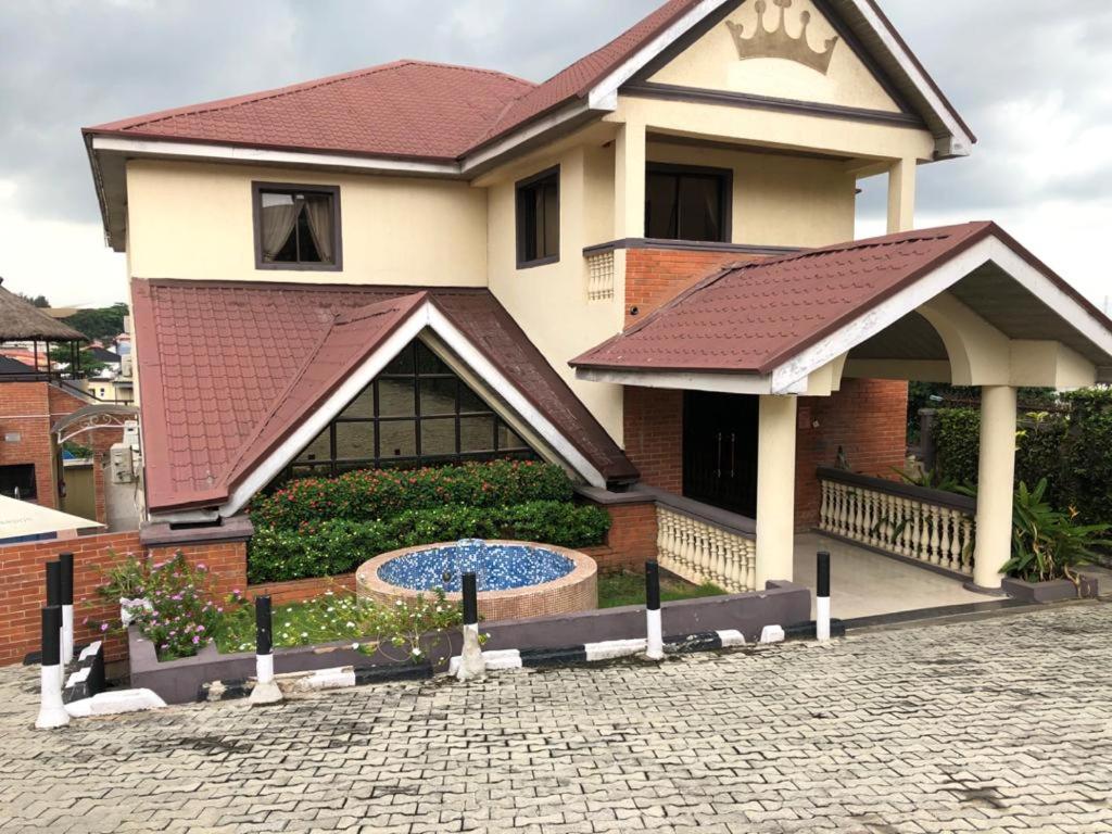 a house with a fountain in front of it at Choice Suites III in Ikeja