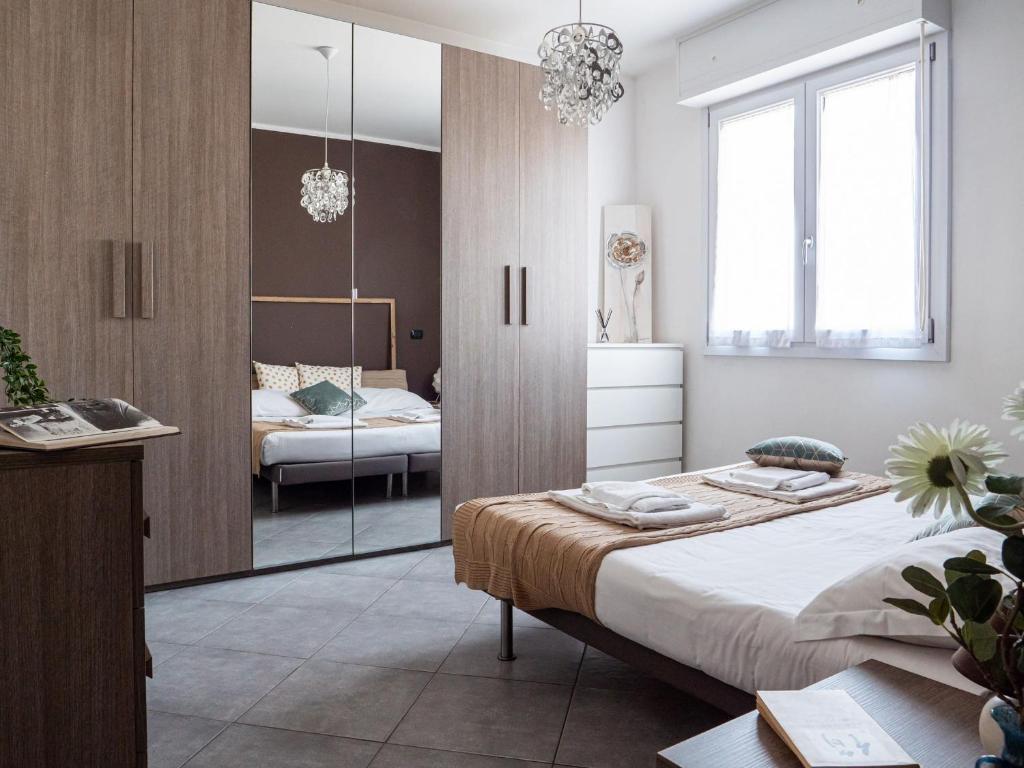 a bedroom with a large bed and a mirror at The Best Rent - Modern two rooms apartment with balcony in Milan