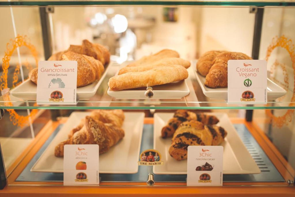 a display case filled with different types of pastries at Hotel Posta in Cecina