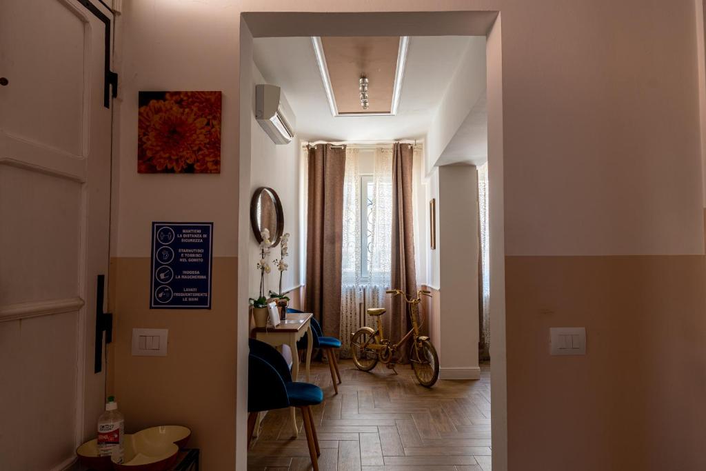 a hallway with a room with a bike in it at Gold Maison in Ferrara