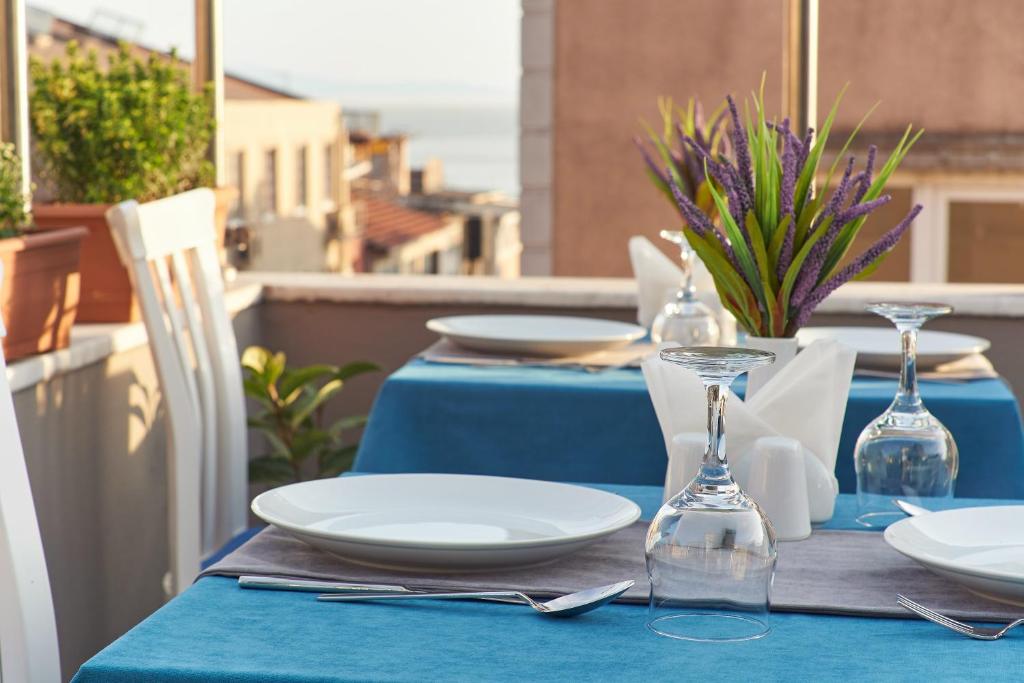 a blue table with plates and glasses on a balcony at Renzo Hotel in Istanbul