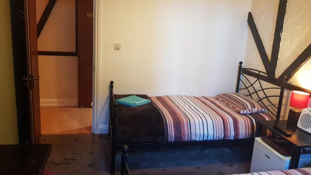 Postel nebo postele na pokoji v ubytování Hour Glass Hotel