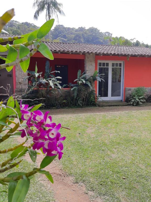 a house with a pink flower in front of it at Ponta negra casa e chalé in Ponta Negra