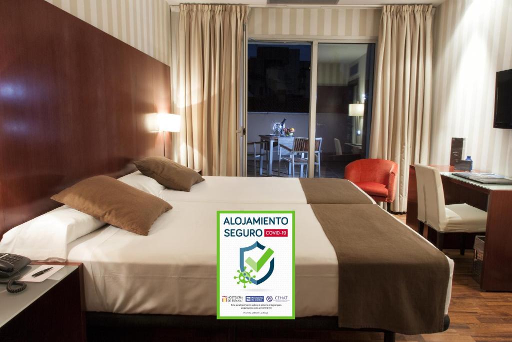 a hotel room with a bed with a amazon sign on it at Zenit Lleida in Lleida