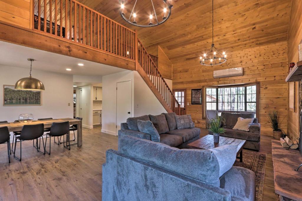 a living room with a couch and a table at Modern Pine Cabin with Game Room, Deck and Fire Pit! in Pine