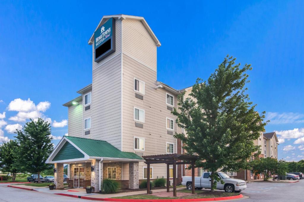 a building with a clock tower on top of it at HomeTowne Studios & Suites by Red Roof Bentonville in Bentonville