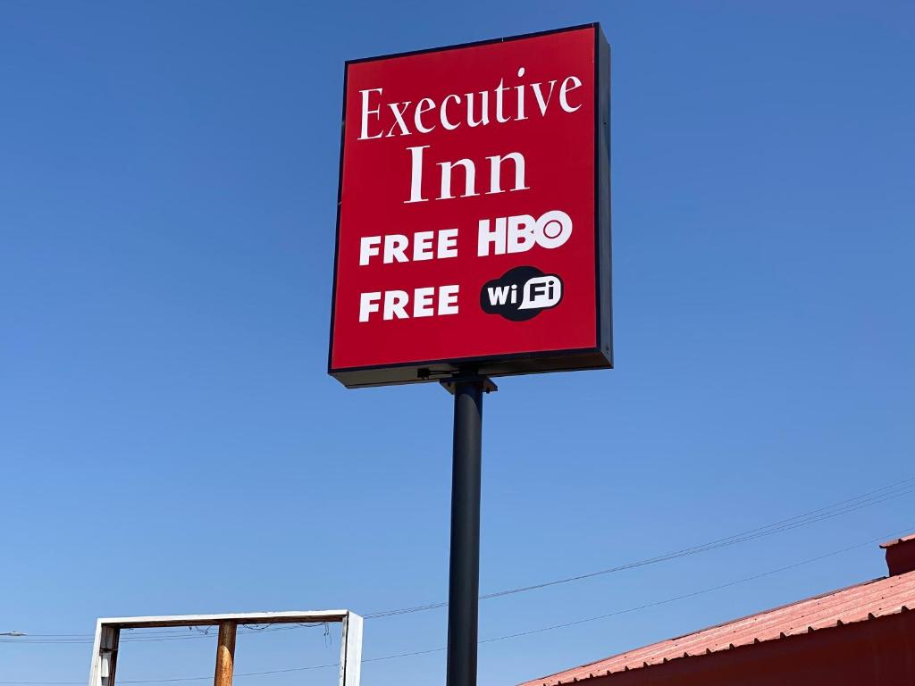 a sign that reads executive im free hog free wifi at Executive Inn in Hobbs