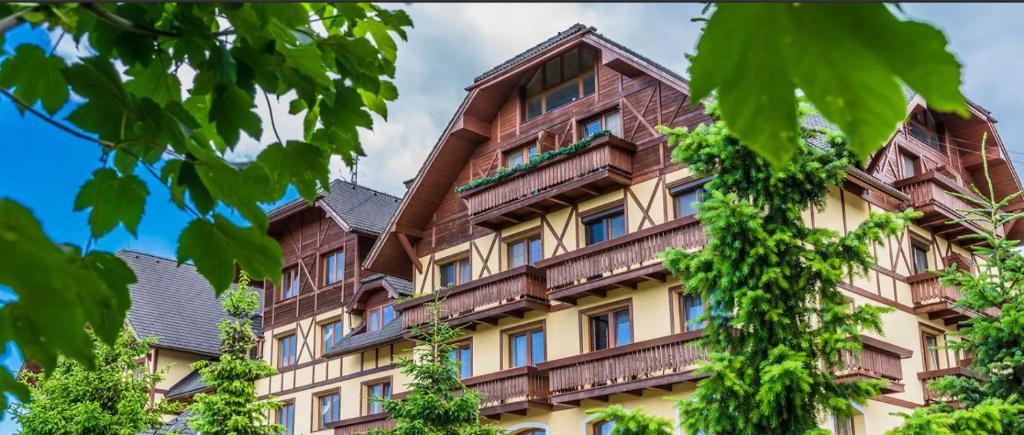 a building with balconies on the side of it at Apartmán Tatry & Resort in Veľká Lomnica