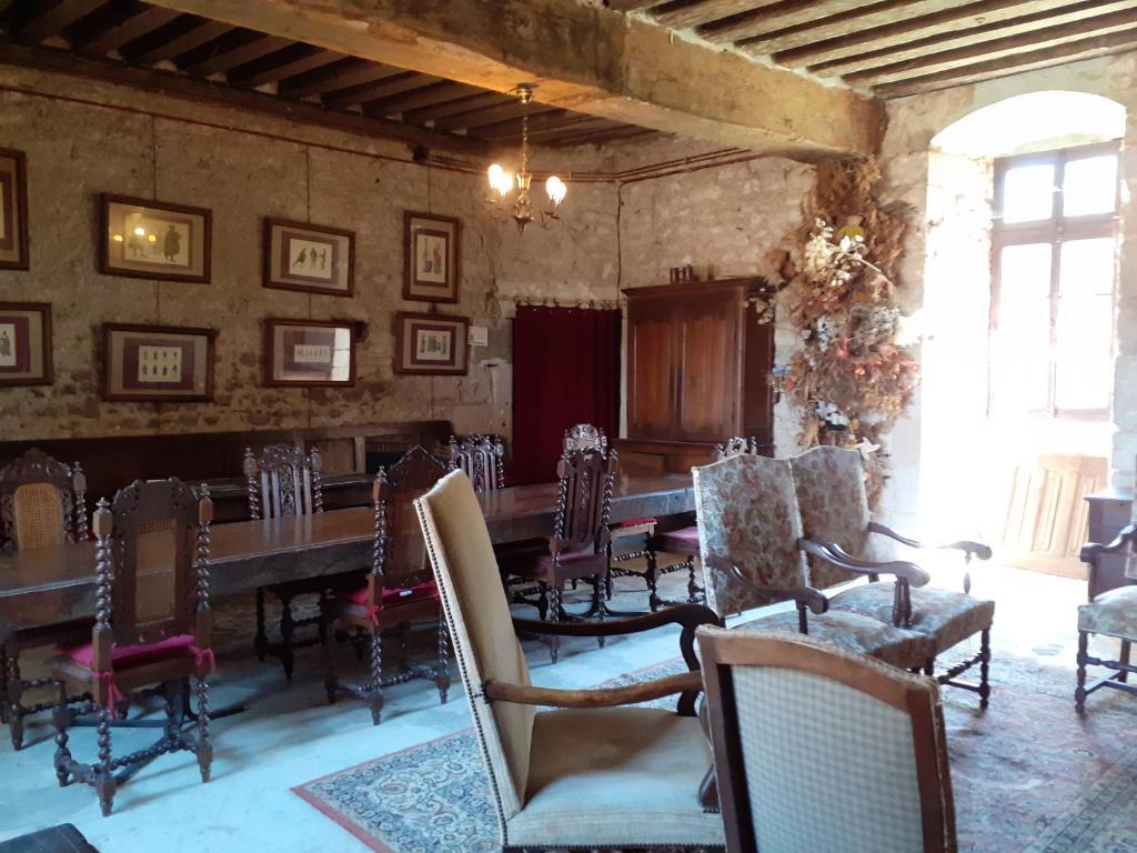 a dining room with a long table and chairs at Chateau de Chémery in Chémery