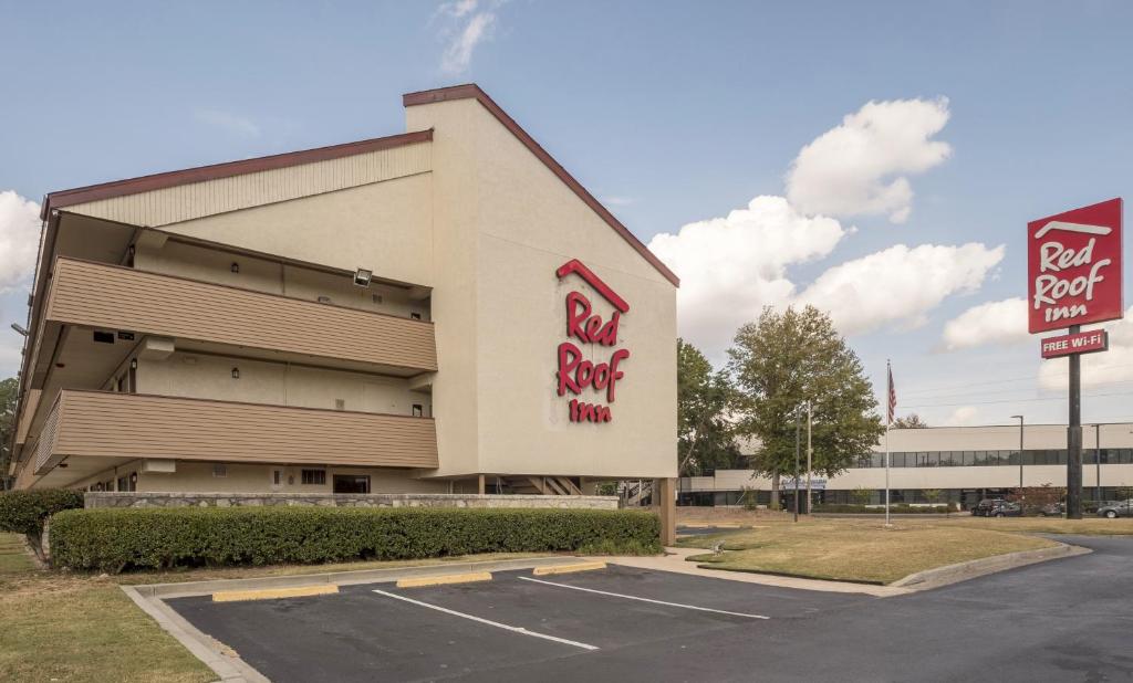 a building with a red rock cafe sign in a parking lot at Red Roof Inn Atlanta-Norcross in Norcross
