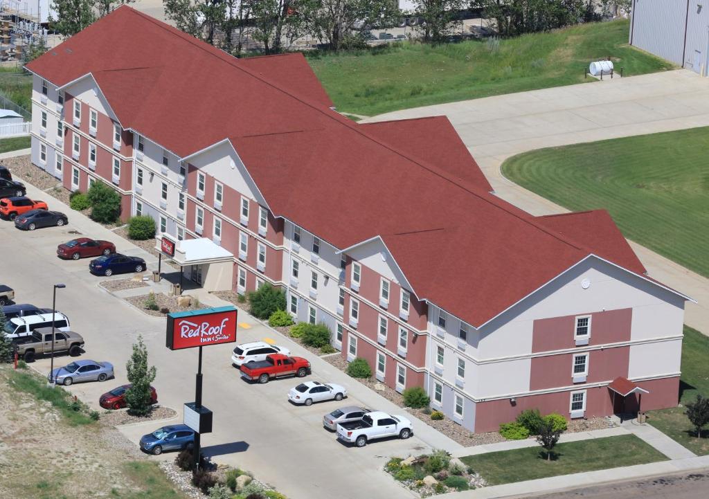 a rendering of a building with cars parked in a parking lot at Red Roof Inn & Suites Dickinson in Dickinson