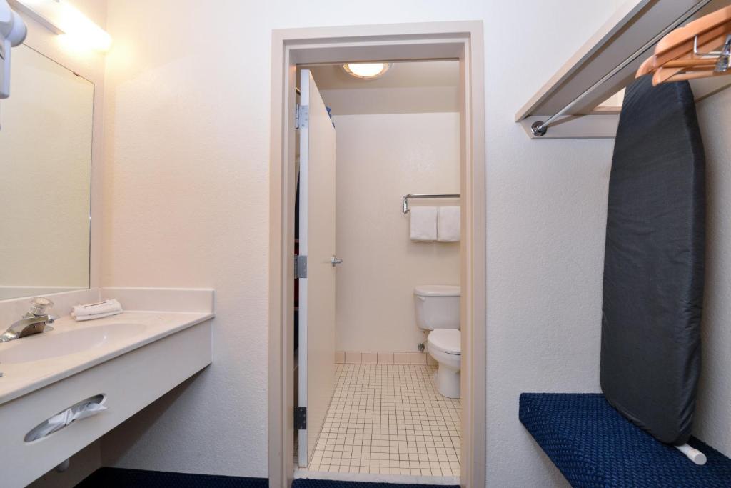 a bathroom with a sink and a toilet and a mirror at Red Roof Inn Clyde in Clyde