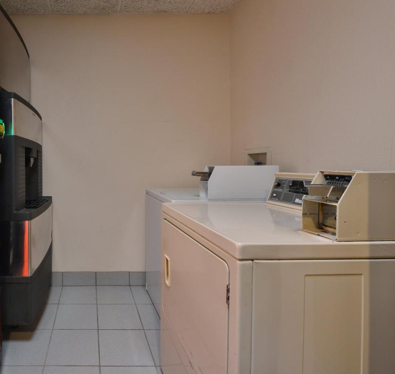 a kitchen with a counter with a stove and a refrigerator at Red Roof Inn Clyde in Clyde