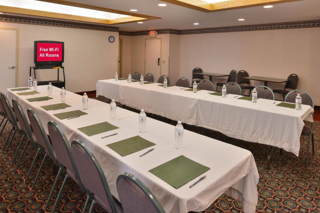 a row of tables in a room with a screen at Red Roof Inn Clyde in Clyde