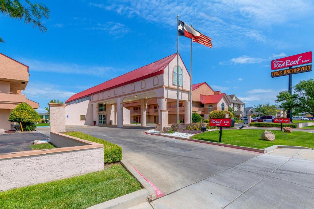 a hotel with a flag on top of a building at Red Roof Inn Amarillo West in Amarillo