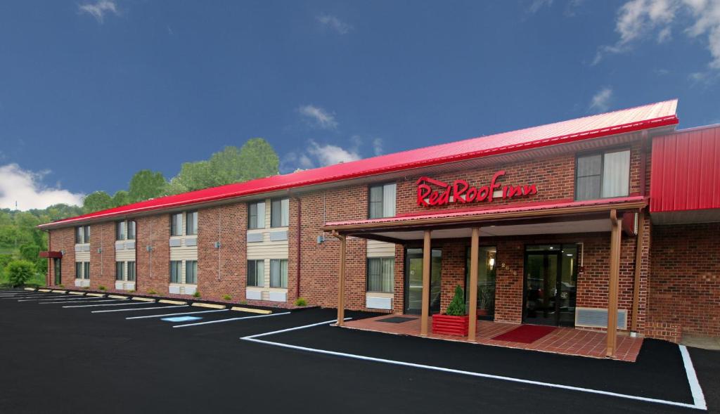a large red brick building with a parking lot at Red Roof Inn Hillsville in Hillsville