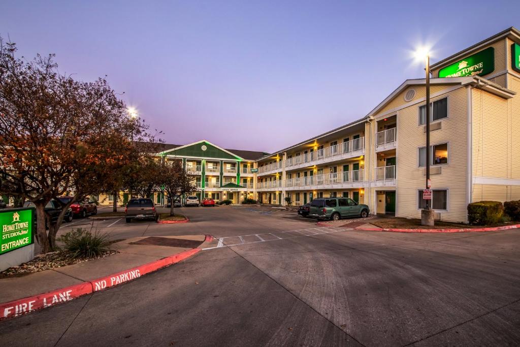 an empty parking lot in front of a hotel at HomeTowne Studios by Red Roof Austin in Cedar Park