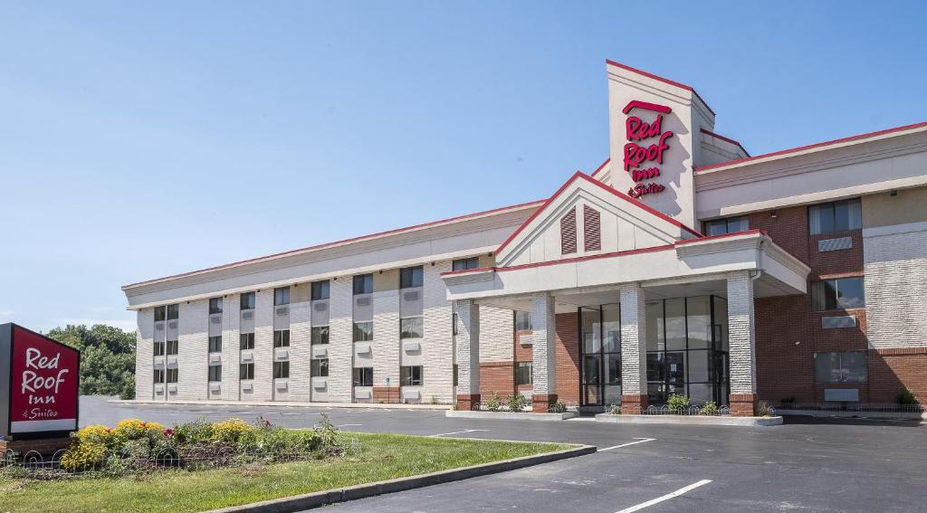 a large building with a sign in front of it at Red Roof Inn & Suites Cleveland - Elyria in Elyria