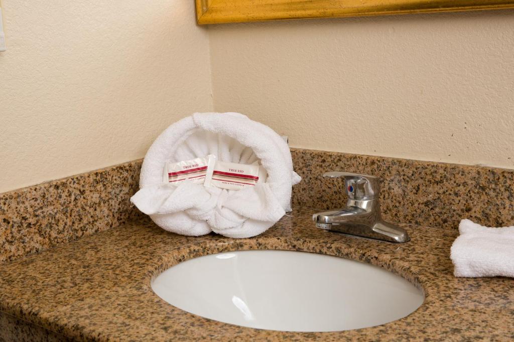 a towel on a counter next to a bathroom sink at Red Roof Inn & Suites Pigeon Forge Parkway in Pigeon Forge