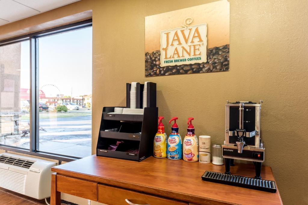 a desk with a coffee maker on it with a window at Red Roof Inn & Suites Pigeon Forge Parkway in Pigeon Forge