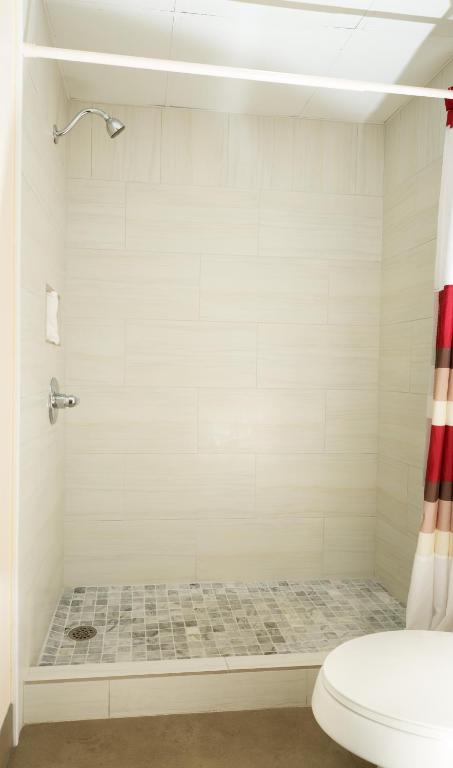 a bathroom with a shower and a toilet at Red Roof Inn & Suites Pigeon Forge Parkway in Pigeon Forge