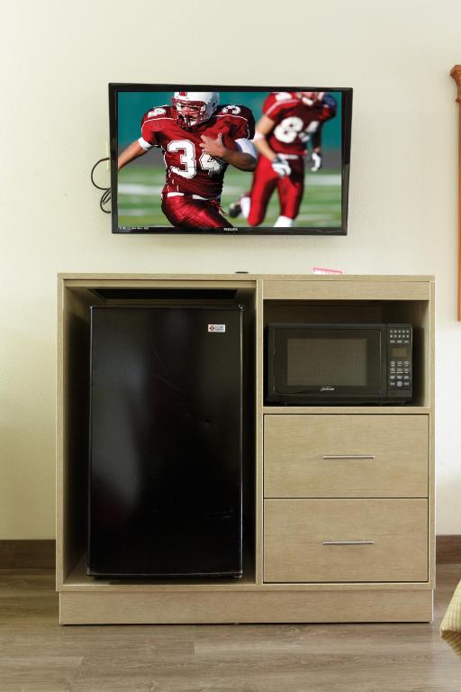 a television with a football player on the screen at Red Roof Inn & Suites Pigeon Forge Parkway in Pigeon Forge