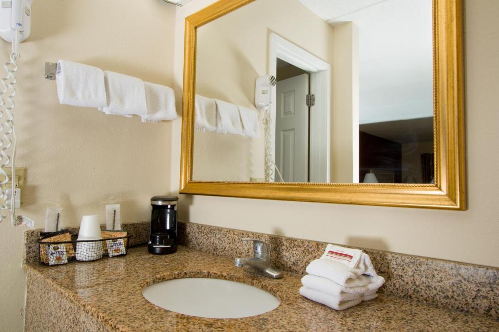 a bathroom with a sink and a mirror at Red Roof Inn & Suites Pigeon Forge Parkway in Pigeon Forge