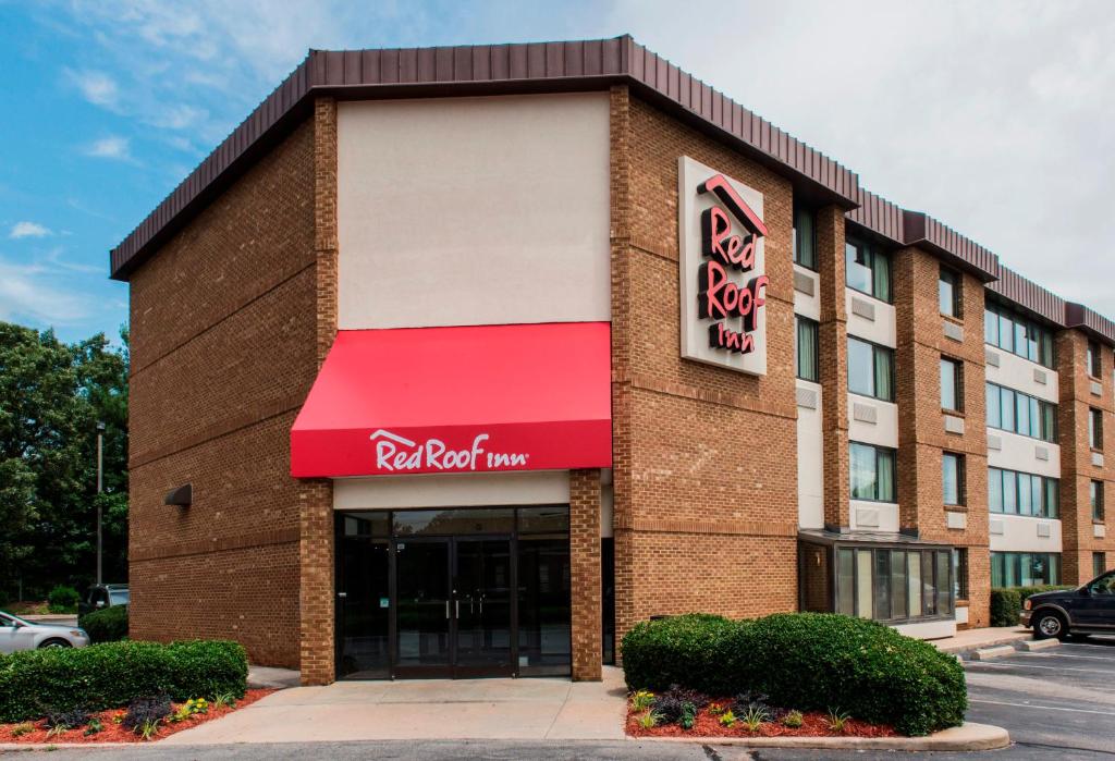 a red roof inn building with a red awning at Red Roof Inn Raleigh Southwest - Cary in Cary