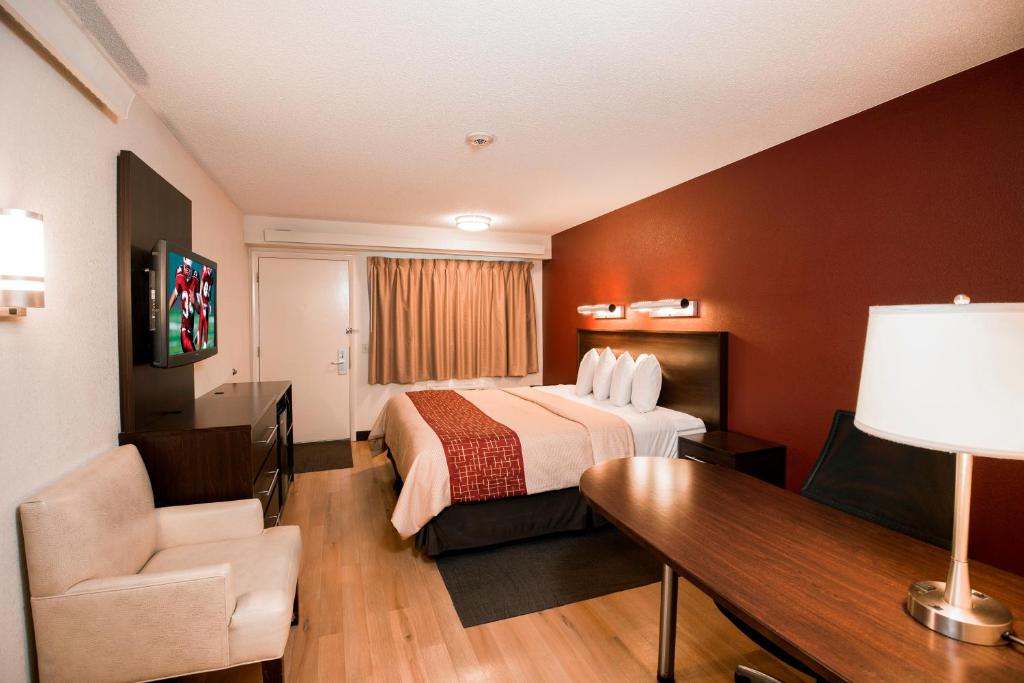 a hotel room with a bed and a desk at Red Roof Inn Benton Harbor - St. Joseph in Benton Harbor