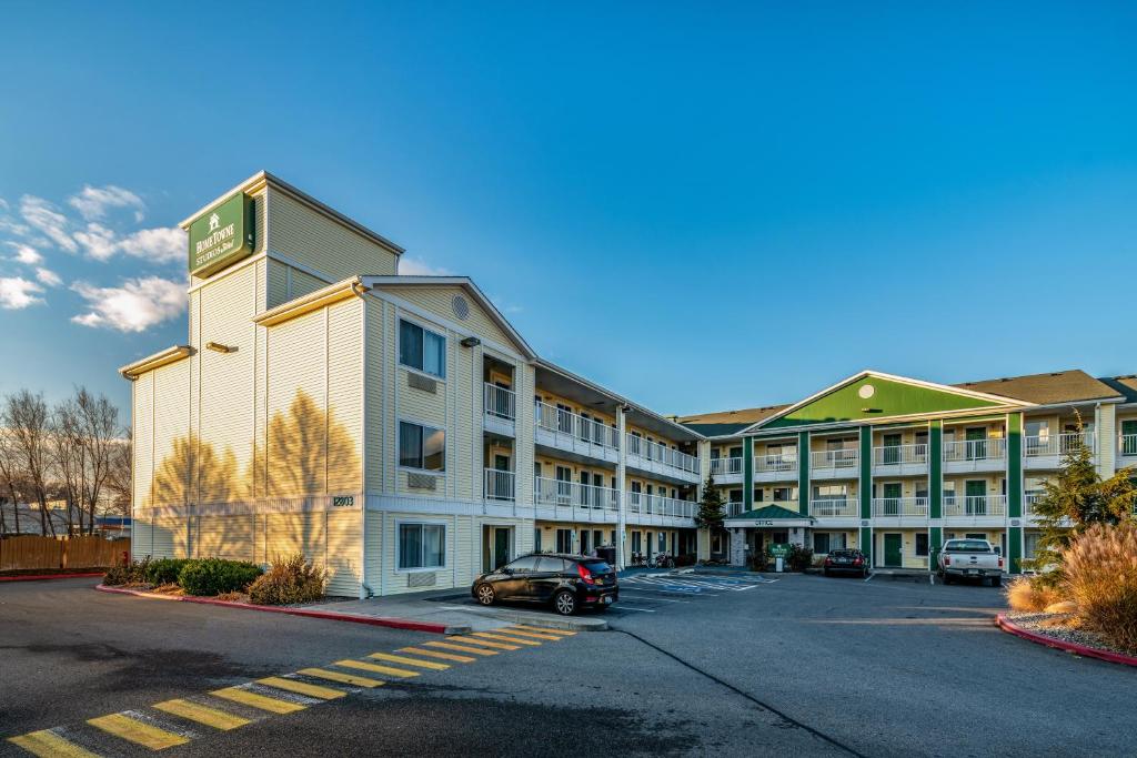 an empty parking lot in front of a hotel at HomeTowne Studios by Red Roof Spokane - Valley in Spokane Valley