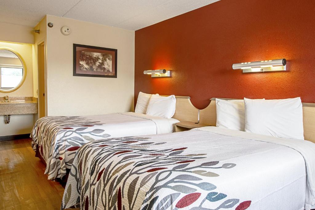 a hotel room with two beds in a room at Red Roof Inn Johnson City in Johnson City