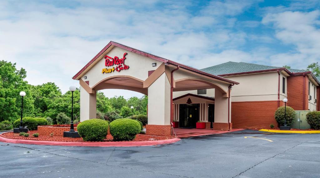 a front entrance to a dunkin donuts restaurant at Red Roof Inn PLUS+ & Suites Opelika in Opelika