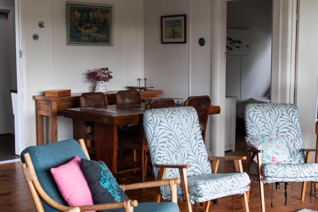 Polperro, a quintessential seaside experience في روب: غرفة طعام مع كراسي وطاولة خشبية