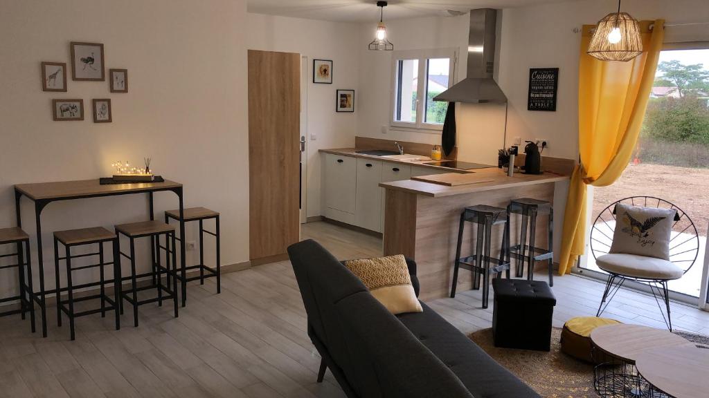 a living room with a couch and a kitchen at La Casita in Chasseneuil-du-Poitou