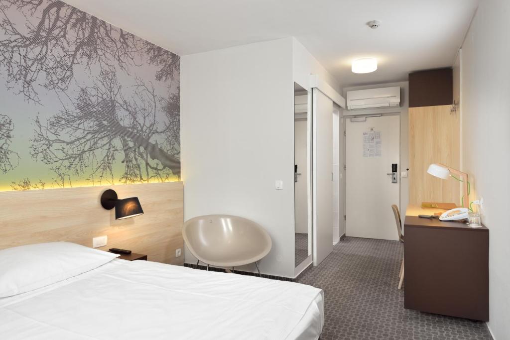 Postelja oz. postelje v sobi nastanitve B&B Hotel Ljubljana Park